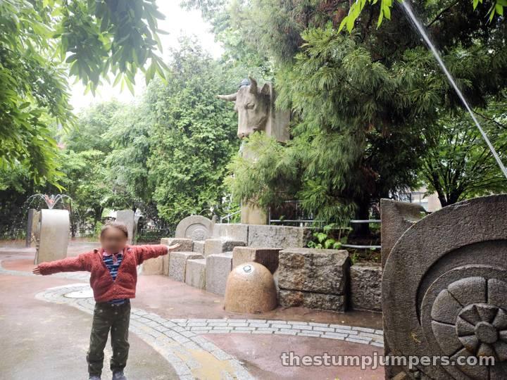 The stone bull heads at the splash pad.