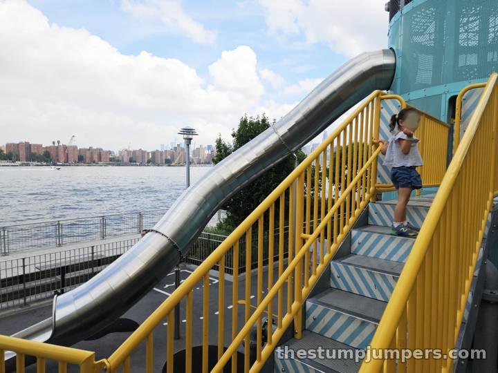 Stairs, slide, and the East River beyond.