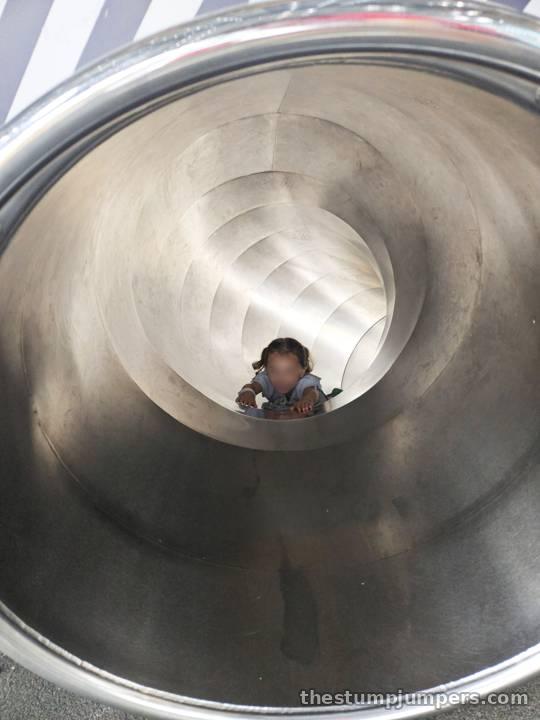 Peekaboo from the bottom of the tube slide.
