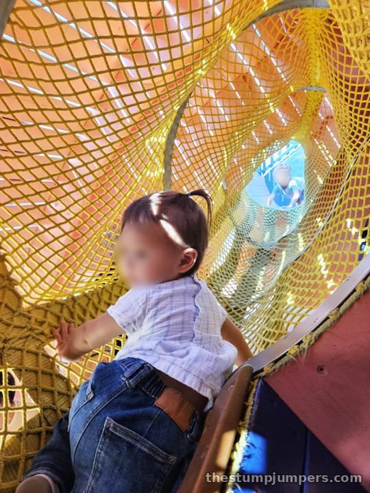 Climbing through the netting.