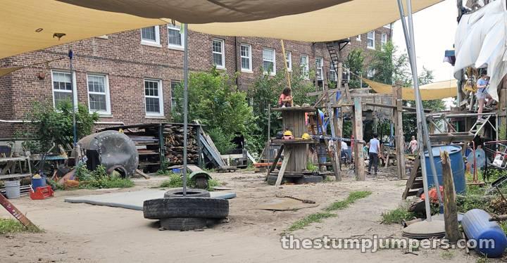 Inside the fence: tires, tarps, and possibility.