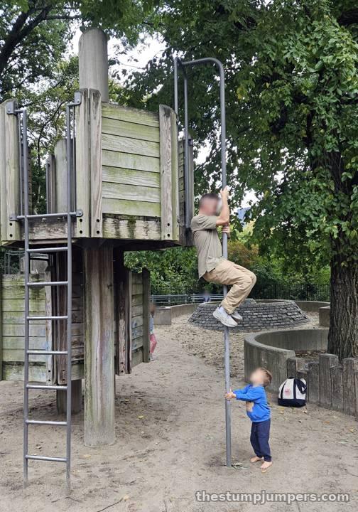 A very long fire pole for a small playground.